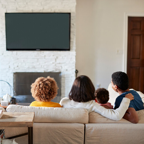 family watching a wall mounted TV
