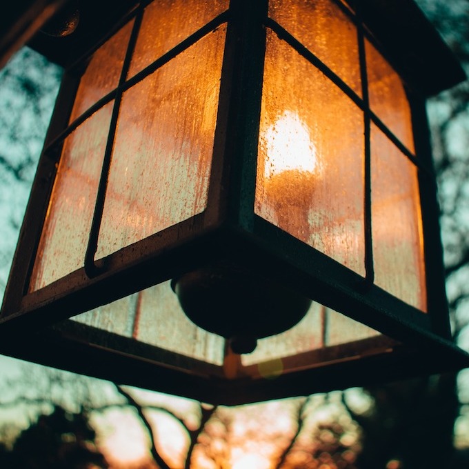 An exterior lantern glimpsed at dusk with the fading light of the sun