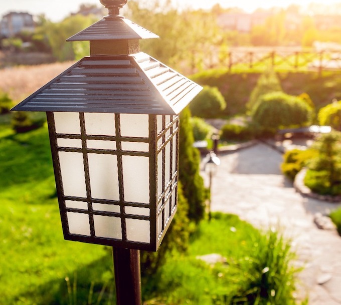 An exterior lantern in a picturesque outdoor Asian-themed garden